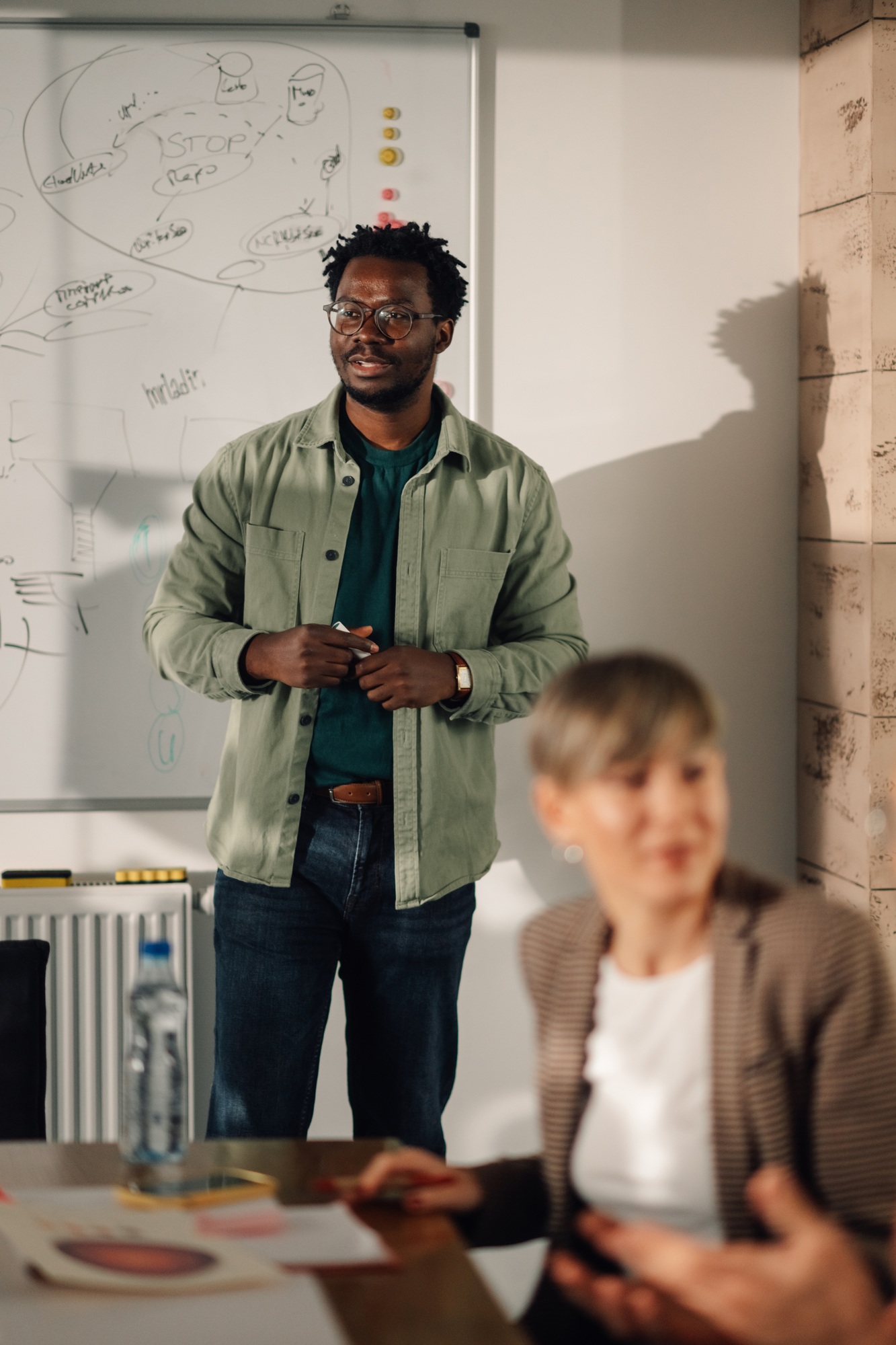 Marketing professional leading business meeting with creative team